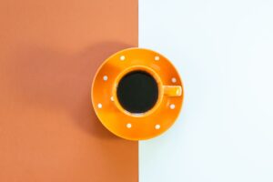 bright orange cup on minimalist background